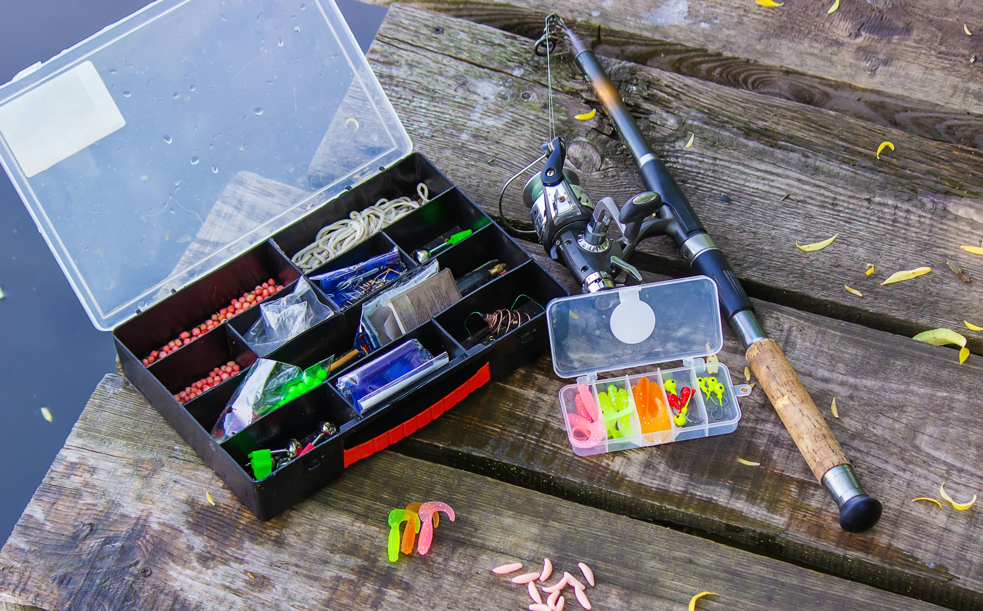 many colorful lures for fishing on the wooden pier. Selective focus